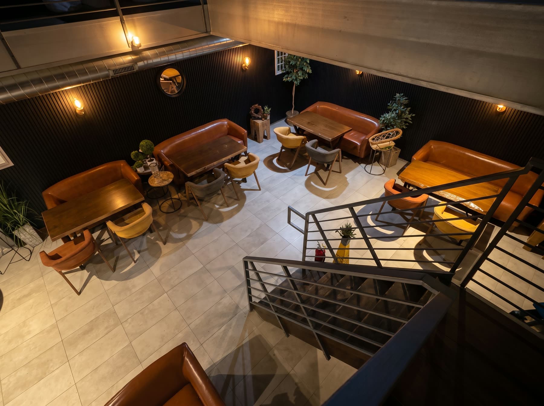 The downstairs lounge at The Turkish Brew, leather banquettes and low tables beside the stairs