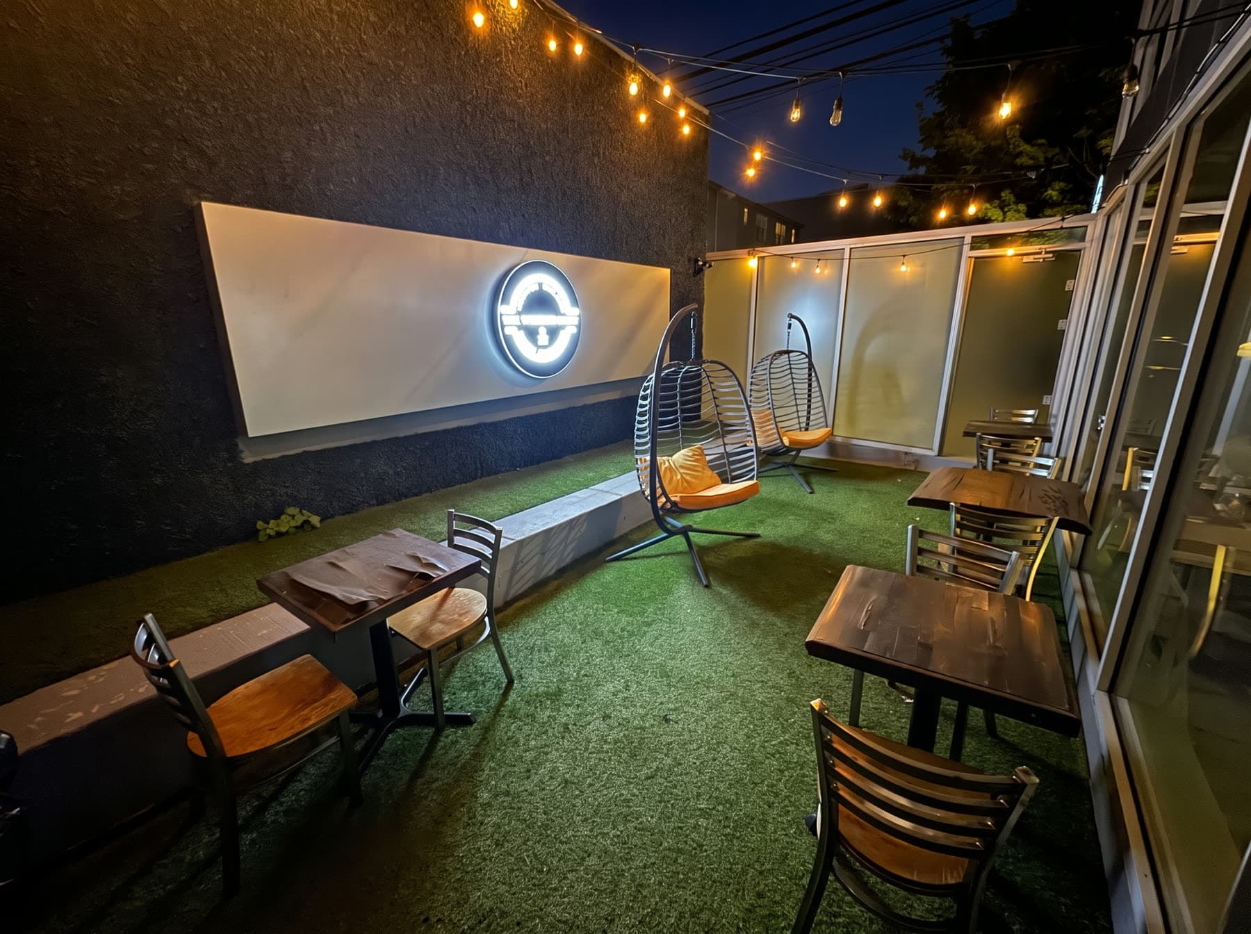 The back terrace at night, strung with lights